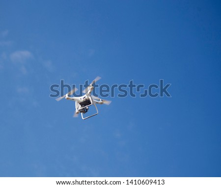 
Drone flies in the blue sky