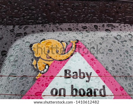 Baby on board poster on   car window