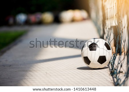 classic soccer ball image with light shadow reflection and mesh around football field.