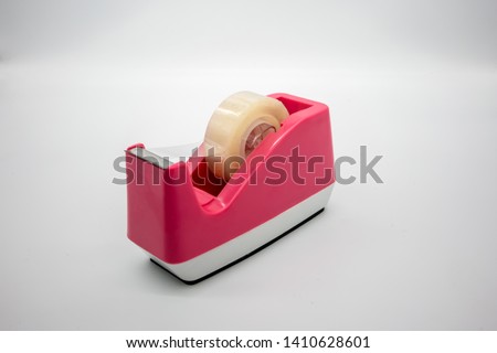 Pink Sellotape scotch tape dispenser isolated on white background Royalty-Free Stock Photo #1410628601