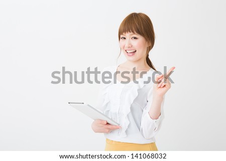 Beautiful young asian woman using tablet computer