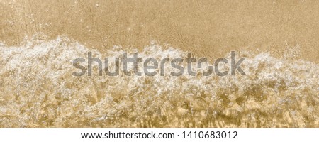 Wave and sandy seashore - panoramic background, top view, beach vacation, copy space