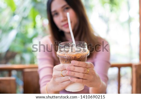 pretty young woman sitting in a cafe with a cup of coffee latte