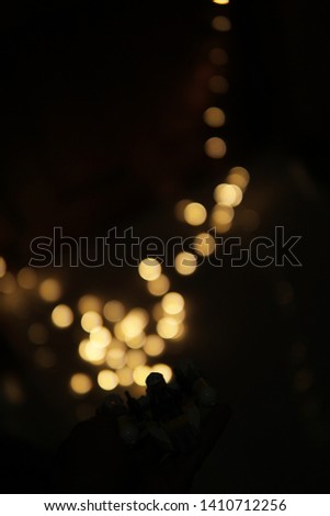shinny blurry gold bokeh balls on dark black background