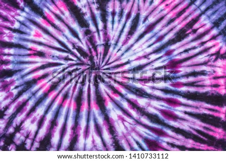 Bright Colorful Abstract Psychedelic Tie Dye Swirl Design Pattern with Black Overlay Stripes.