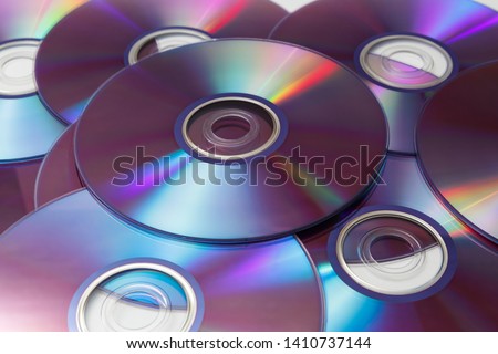 CD's, DVD's on white background Royalty-Free Stock Photo #1410737144