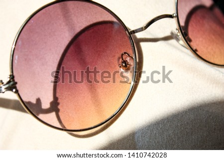 Soft focus closed up gradient purple to orange sunglasses on sunlight give an shadow, summer vibe. Royalty-Free Stock Photo #1410742028