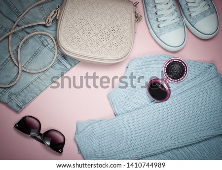 Fashionable women's clothing, shoes and accessories on pink background. Bag, jeans, bags, sanglasses, sweater. Shopping concept, shopaholic.