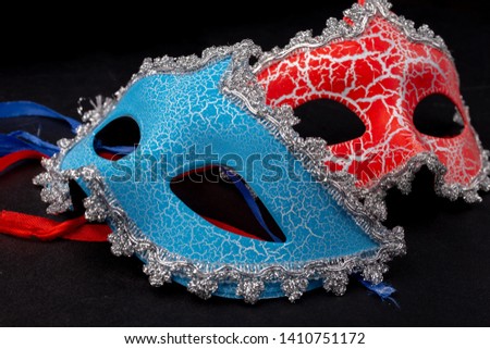 masquerade masks red and blue on a black background