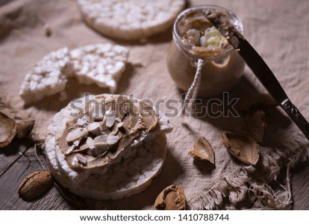 Homemade almond butter on a slice of rice crispbread. Closeup