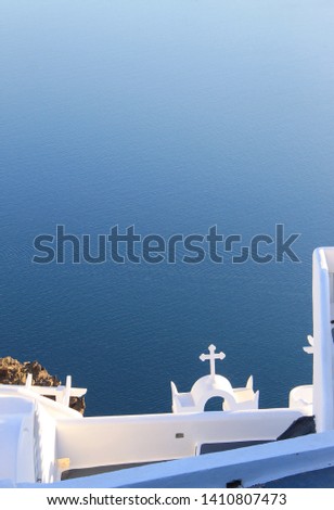 Santorini caldera view church and bright clear sea water surface. Cycladic landscape.