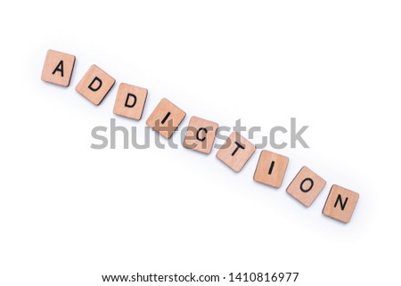 The word ADDICTION, spelt with wooden letter tiles over a plain white background. 
