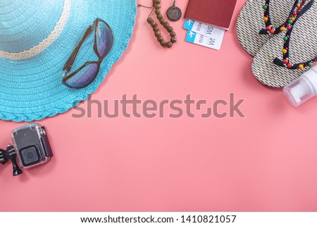 Travel holiday supplies: hat, sunglasses, flip flops, camera passport and airline tickets on pink background. Concept of going on vacation at sea. Top view. Flat lay