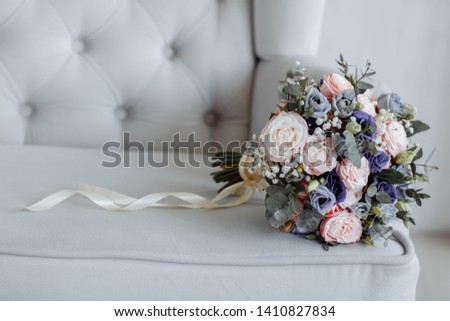 Bright Beautiful bridal bouquet with roses and ribbon Royalty-Free Stock Photo #1410827834