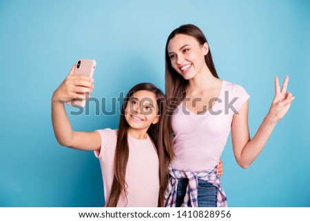 Portrait of two nice cute charming attractive lovely cheerful cheery straight-haired girls posing taking making selfie showing v-sign isolated on bright vivid shine green blue turquoise background