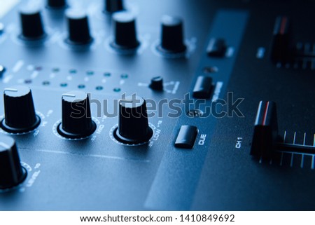 Contrastful Close-up of Club DJ mixer used in Electronic Dance Music production studio