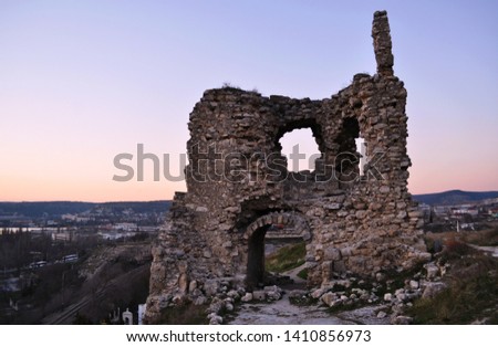 Ruins of ancient and abandoned fortress or tower or castle or fort Calamita in Inkerman, Sevastopol, Crimea. Medieval historic stone building on mountain Royalty-Free Stock Photo #1410856973