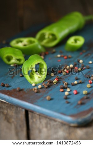 Chili green pepper on the top of board on a wooden kitchen wooden table. Rustic. 