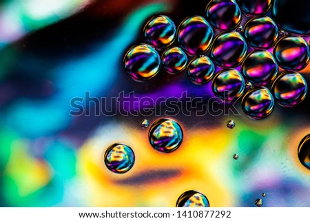 Oil and water macro photograph against a colourful background