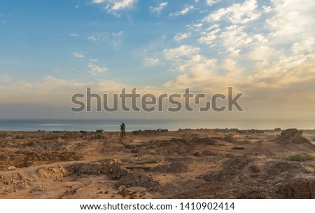 Desert and building site in front of the Sea