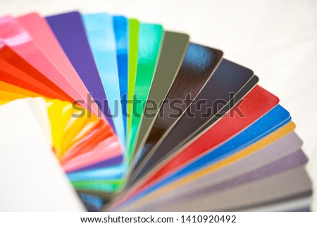 Close-up of color palette guide of stickers for decoration on white background.