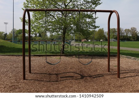 Swingset taken at a park in NJ.  Royalty-Free Stock Photo #1410942509