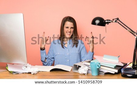 Young student girl making rock gesture