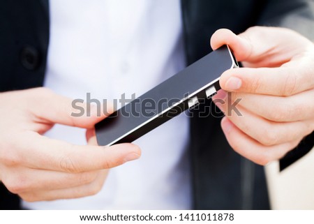 Man holding mini adapter for laptops and flash memory