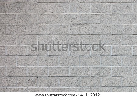 Section of light grey rough textured block wall background Royalty-Free Stock Photo #1411120121
