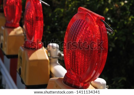 red warning lights at plastic barriers at a road construction site