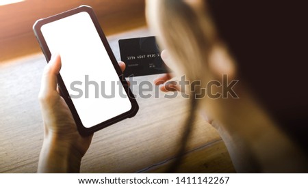 A woman holding cellphone and credit card. online shopping concept or mobile banking concept