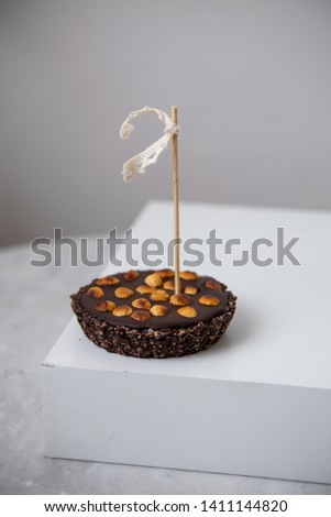 Tartlets with nuts and chocolate on marble background with copy space