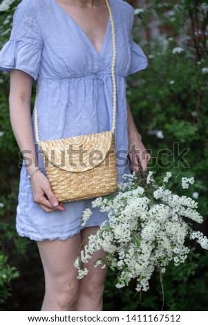 Bouquet of spring apple flowers in woman hands outdoor. Summer concept