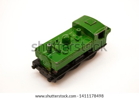 green toy locomotive on a white background