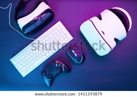 Keyboard, mouse, gamepad and pair of virtual reality headset. Concept of virtual reality, simulation, coop gaming and future technology.