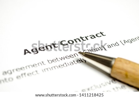 Agent contract with wooden pen