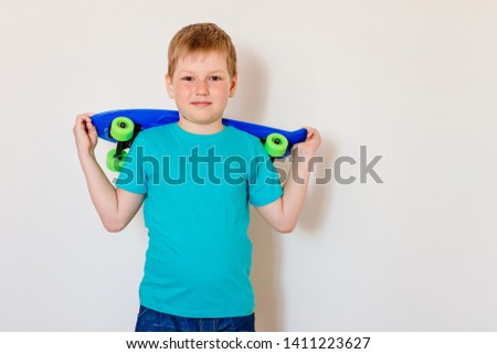 seven-year-old ?hild holds a skate on a white background