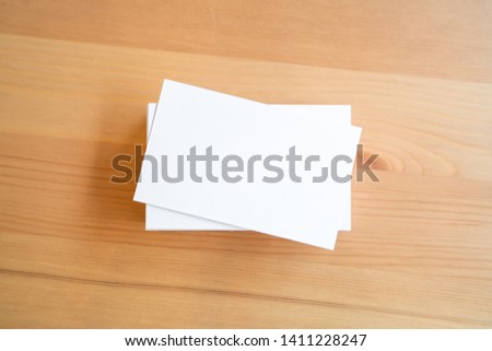 Blank business cards on wooden surface.