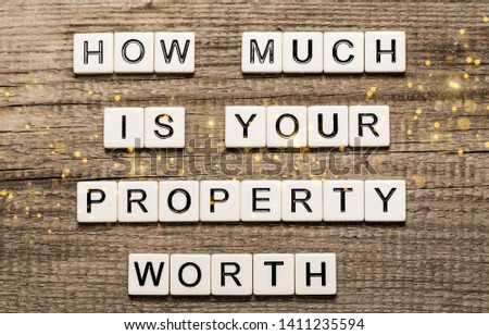 Business man pointing to transparent board with text: How Much is your Property Worth?