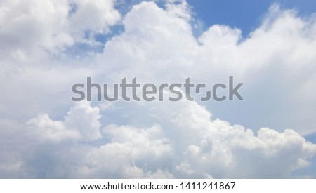 Beautiful blue sky background with sparced white clouds. Panorama.