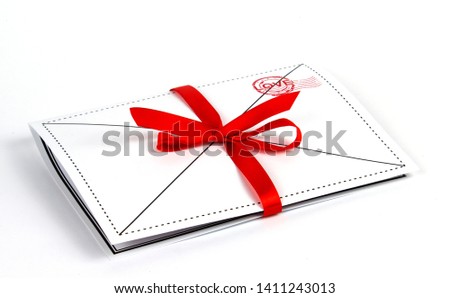 postcard tied with a red ribbon on a white background