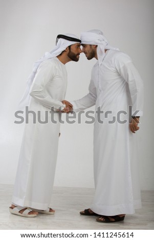 Two emirati men on plain background Royalty-Free Stock Photo #1411245614