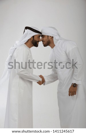 Two emirati men on plain background Royalty-Free Stock Photo #1411245617
