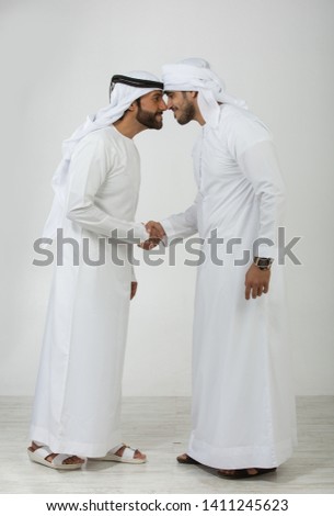 Two emirati men on plain background Royalty-Free Stock Photo #1411245623