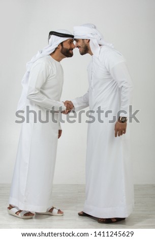Two emirati men on plain background Royalty-Free Stock Photo #1411245629