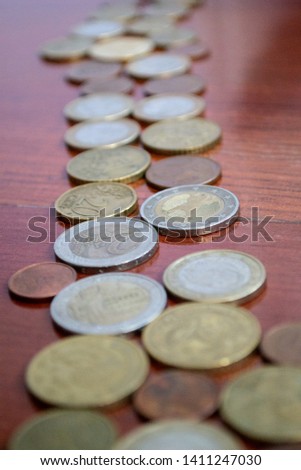 row of euro coins on a wooden background