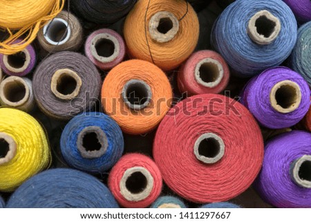 multicolor skeins and coils of threads. atelier sewing accessories background top view