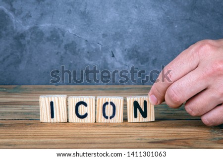 Icon - word from wooden letters on wooden table