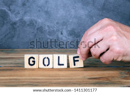 Golf - word from wooden letters on wooden table