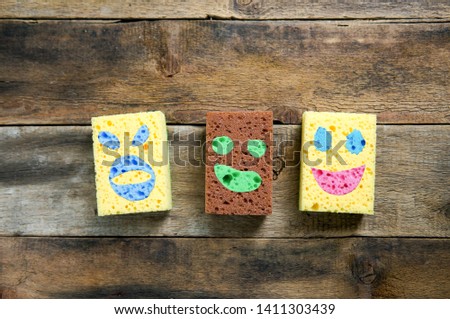  Funny sponges. Sponge cartoons concept over wooden background. Three friends together